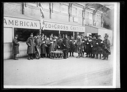 Waiting for a convoy of American soldiers to arrive. The British military band, which has been sent to welc…