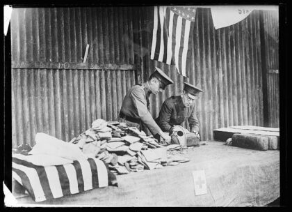 Preparing sandwiches for the men of an arriving troopship. Every transport is met at the docks by a deputat…