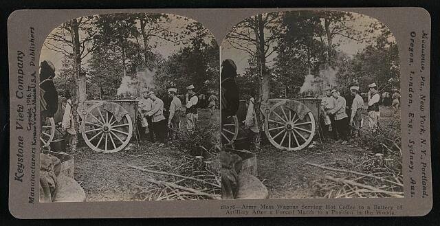 Army mess wagons serving hot coffee to a battery of artillery after a forced march to a position in the woods