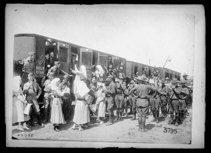 [American Red Cross Canteen workers go down to the station at Issoudun to serve coffee and sandwiches to a…