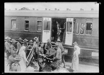 When a trainload of American wounded goes through the workers from the American Red Cross canteen at Issoud…