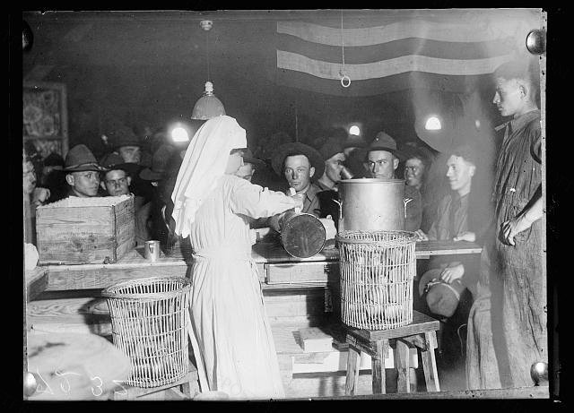 American Red Cross canteen worker serving coffee to American soldiers in the canteen at Issoudun