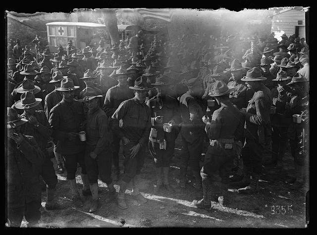 Villafranca, Italy. Doughboys gathered about an American Red Cross canteen. Hot coffee and doughnuts prove…